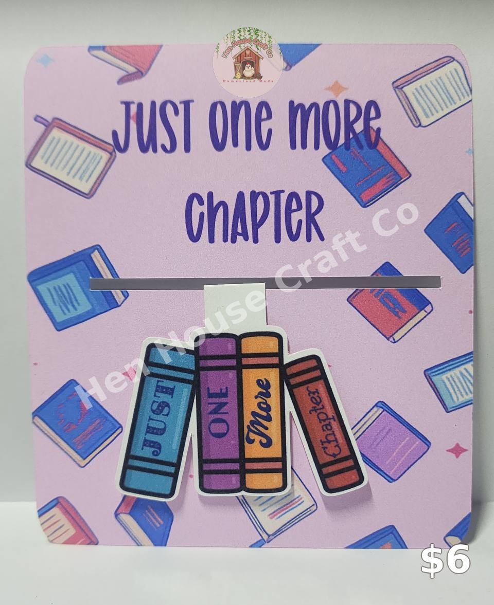 Just One More Chapter magnetic bookmark with colorful book spines on a pink book-print card
